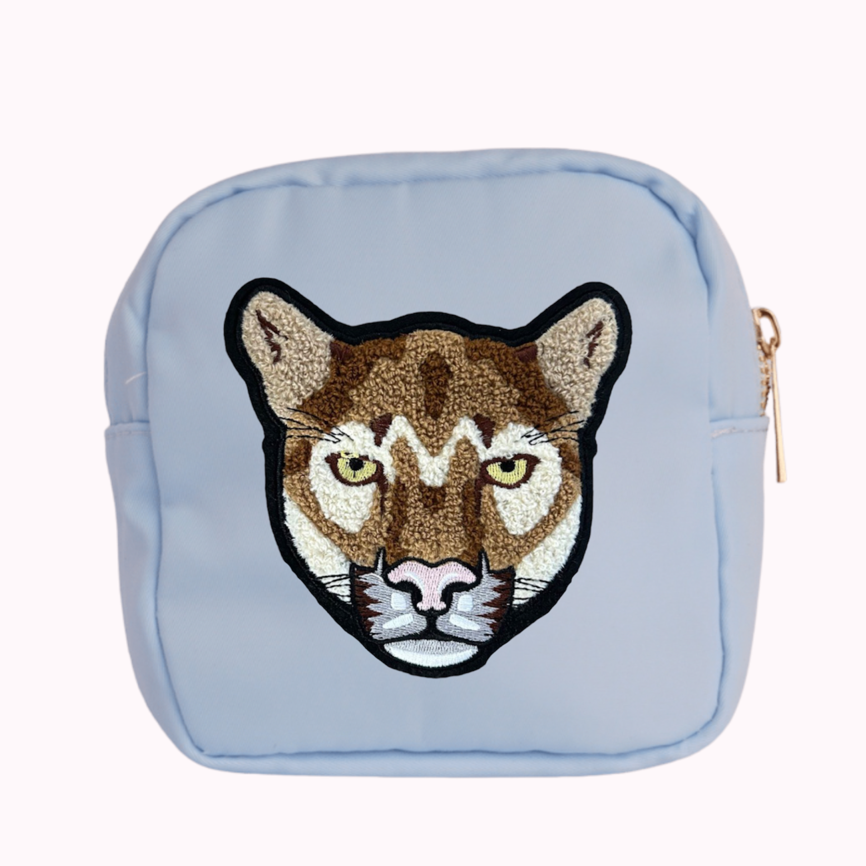 Light blue mini crossbody bag with cougar patch. 