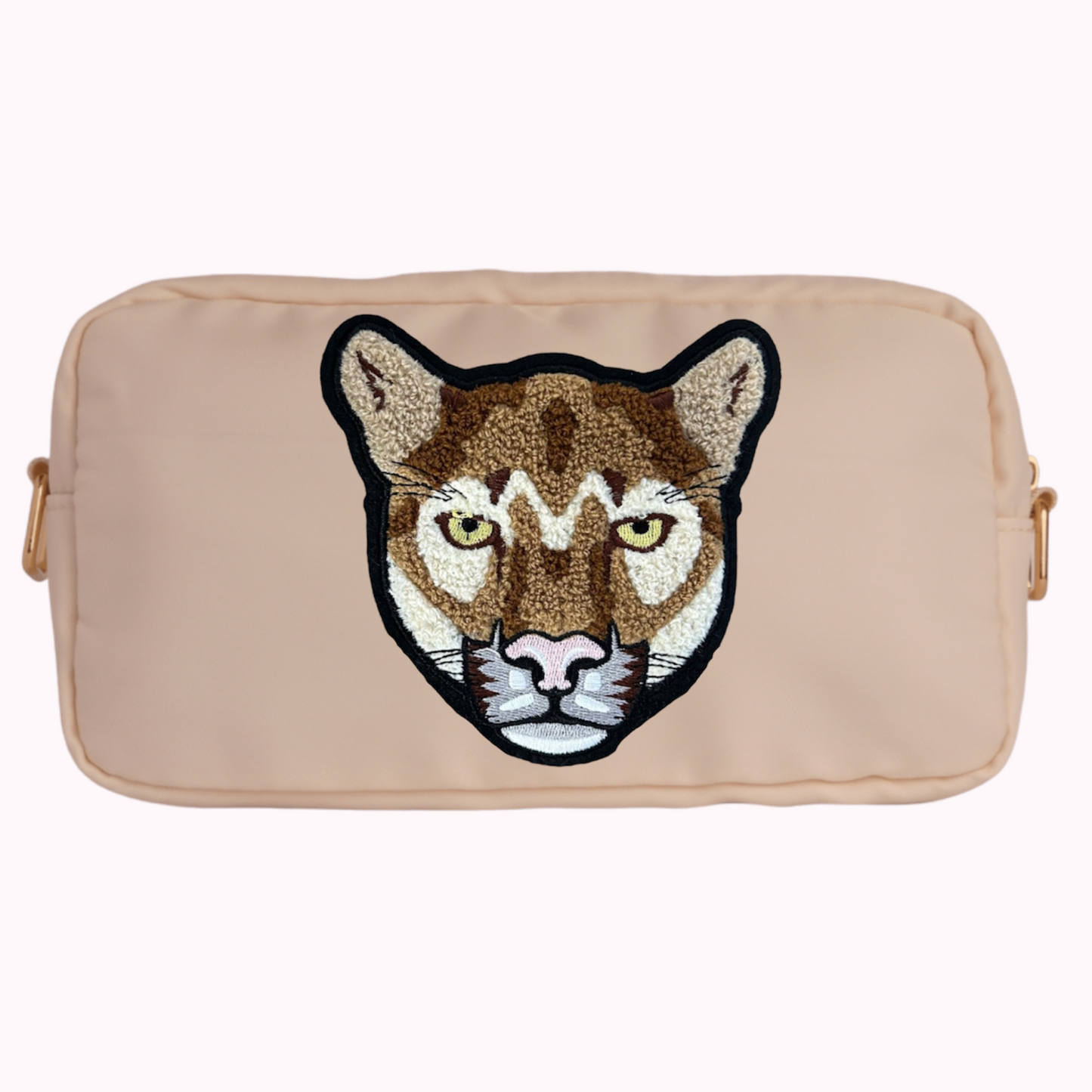 Cream classic crossbody bag with cougar patch. 