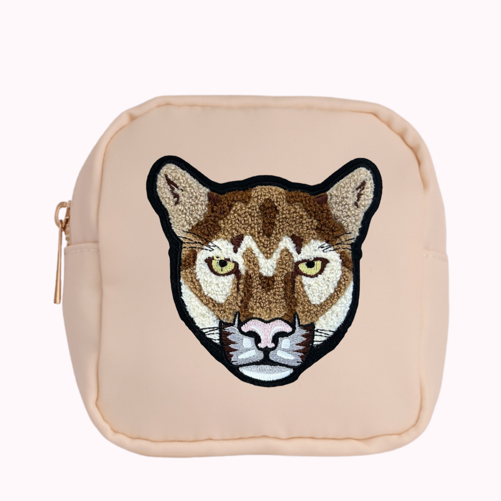 Cream mini crossbody bag with cougar patch. 