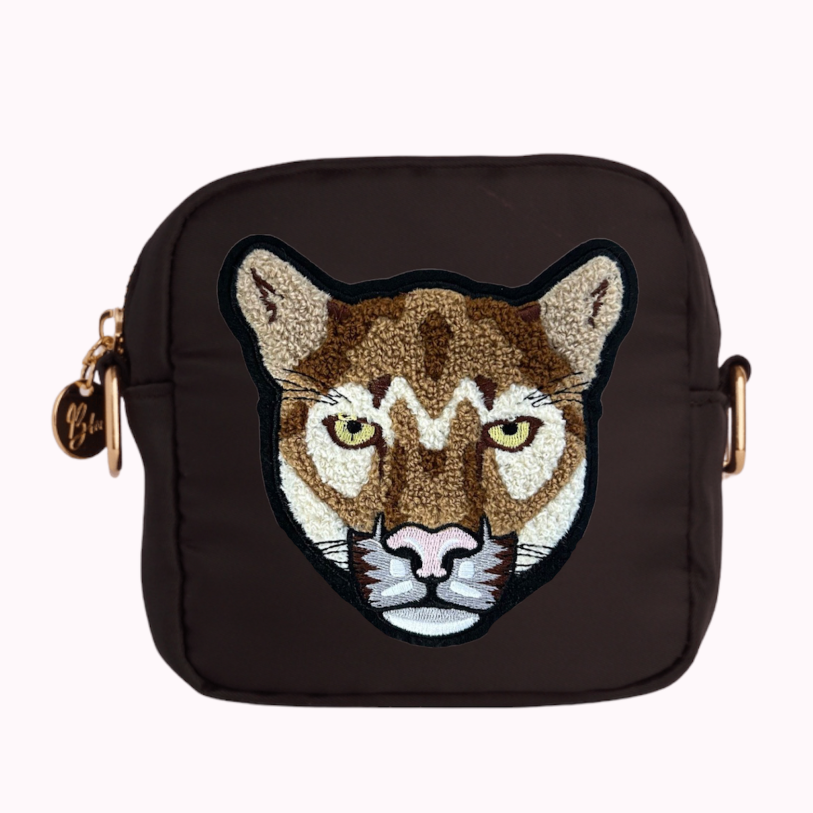 Black mini crossbody bag with cougar patch. 